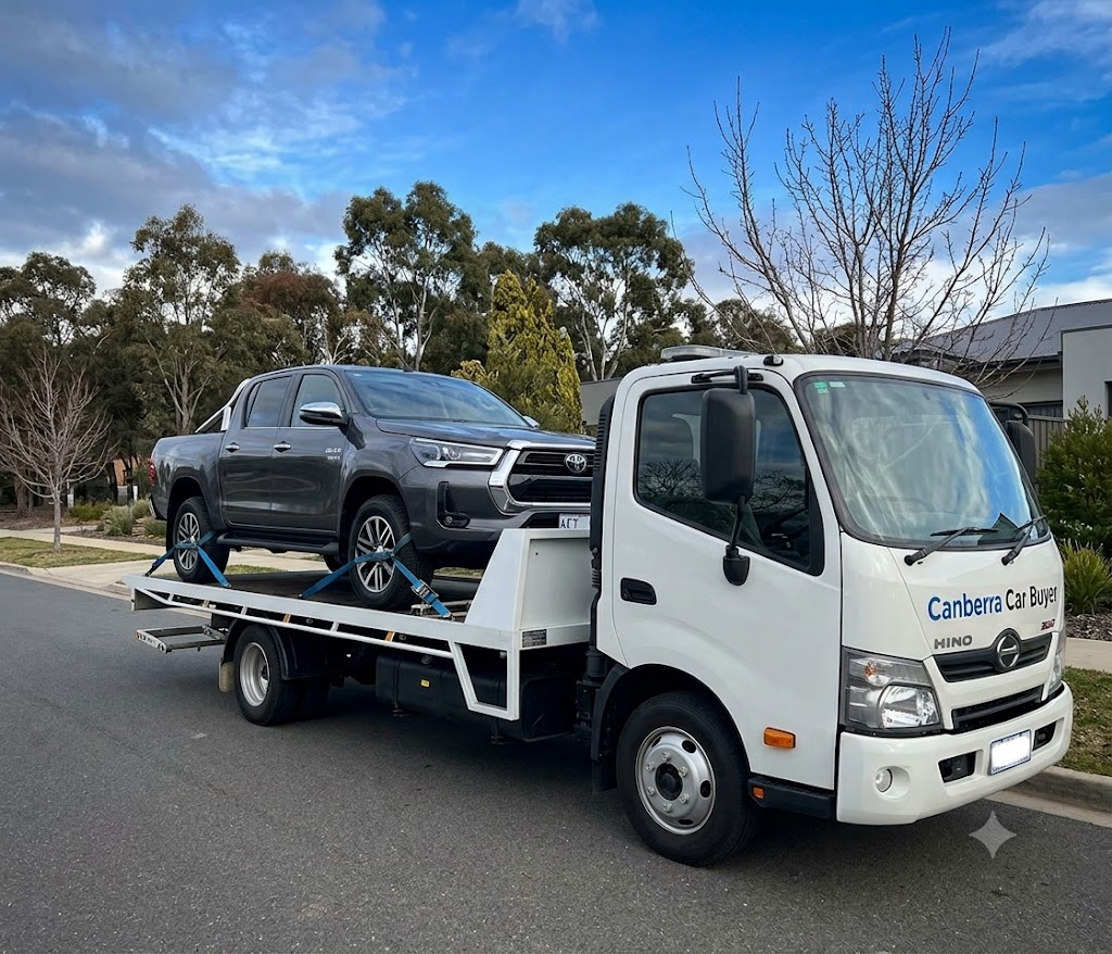 Damaged car being loaded onto a tow truck for scrap removal